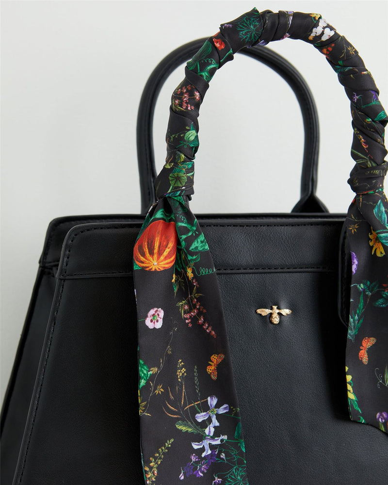 Schwarze Handtasche mit botanischem Kürbis-Print